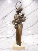 A bronze figure of The Madonna and Infant Christ, on marble plinth, impressed initials CA,