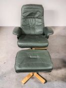 A Scandinavian green stitched leather upholstered swivel lounge armchair and matching footstool,