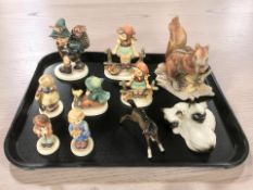 A group of Goebel figures of boys and girls, Beswick foal, Royal Doulton Siamese cats,