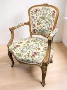 A continental carved beech and needlework salon armchair, width 63 cm.