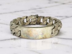 A heavy-gauge silver identity bracelet, length 20cm. CONDITION REPORT: 97.