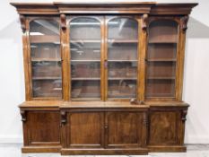 A Victorian mahogany break front four door bookcase, 280 cm x 54 cm x 241 cm.