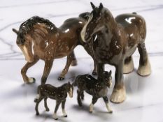 A Beswick brown gloss shire horse, height 22 cm, a brown gloss cantering horse and two foals.