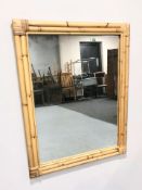 A bamboo framed mirror, 92 cm x 72 cm.