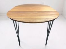 A contemporary Scandinavian oval dining table on tapering metal legs, 153 cm x 105 cm x 74 cm.