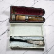 Two antique cheroot holders with silver mounts