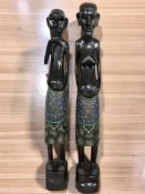 A pair of African carved wooden statues with polychrome painted decoration, height 82 cm.