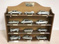 A set of Danbury Mint Jaguar classic motorcars pewter scale models, with display shelf, width 40 cm.