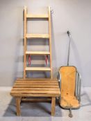 A wooden step ladder, a luggage stand and a metal framed barrow.