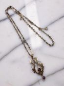 An Edwardian 9ct gold amethyst and garnet pendant on chain CONDITION REPORT: 7.