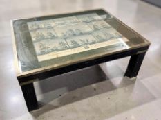 A brass mounted rectangular coffee table depicting naval ships, length 92 cm.