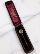 An enamel and seed pearl stick pin, stamped 15ct,