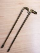 An antler handled walking stick and a horn handled stick, both with silver mounts.