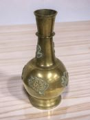 An embossed brass bulbous vase, height 32 cm.