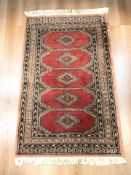 A Lahore Bokhara rug, Pakistan, 136 cm x 79 cm.