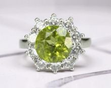 A 2.7ct natural peridot cluster ring, size O, with AIG certificate.