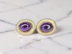A pair of 9ct gold amethyst cabochon ear studs CONDITION REPORT: 1.
