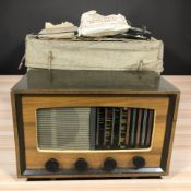 A vintage Pye valve radio, a small tray of components, and a wooden box with canvas cover.
