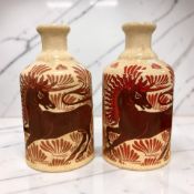 A pair of crackle glaze bottle vases decorated with William de Morgan unicorn motif, height 15cm.