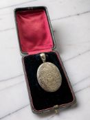 A Victorian engraved silver locket, Birmingham 1877, length 5cm, in an antique box.