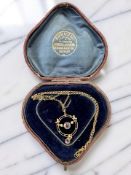 An Edwardian amethyst and seed pearl pendant on 9ct gold chain CONDITION REPORT: 4.