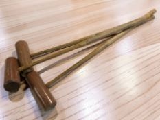 Three vintage wooden croquet mallets, length 93 cm.