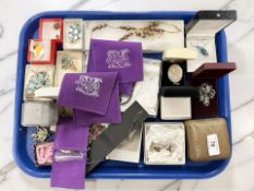 A group of costume jewellery, a sterling silver locket, brooches, etc.