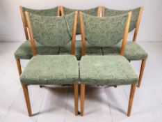 A set of five Danish oak framed dining chairs in green upholstery.
