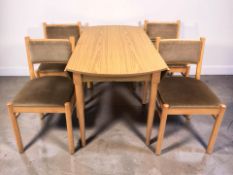 A 20th century Schreiber teak veneered drop leaf dining table and a set of four chairs.