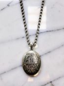 A Victorian silver locket on chain, Birmingham 1878, chain 44cm long.