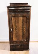 A 19th century continental mahogany single door cabinet, 75 cm x 37 cm x 157 cm.
