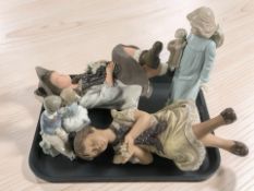 A Nao figure of a boy and girl sat on a bench,