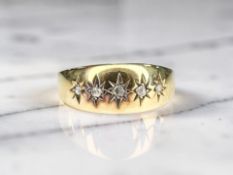 An 18ct gold five stone gypsy-set diamond ring, size N CONDITION REPORT: 1.