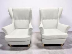 A pair of Ikea contemporary wingback armchairs in light grey fabric, width 82 cm.