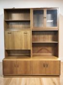 A G-Plan teak cocktail wall unit fitted cupboards and shelves, 163 cm x 46 cm x 198 cm.