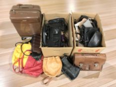 A group of various handbags, satchels, hard shell luggage case, etc.