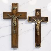 A walnut and gilt spelter crucifix, height 41 cm, plus a further similar example.