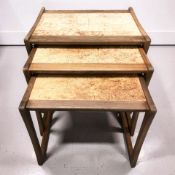 A 20th century teak nest of three tables.