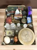 A group of tins, ostrich and emu eggs, circular foot stool, glass decanters, a plated vesta case,