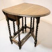 An Edwardian oak barley twist gateleg occasional table, length 62 cm.