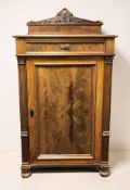 An early 20th century continental walnut and pine single door cabinet with shelved interior,