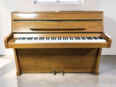 A Danemann walnut cased overstrung upright piano, width 140 cm.