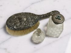 An embossed silver backed hair brush, length 26 cm,