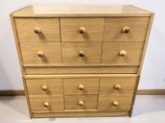A pair of Scandinavian pine effect six drawer chests, each 80 cm wide.