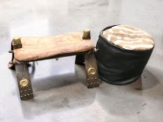 A camel stool and a hide upholstered cushion.