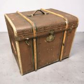 An early 20th century canvas and wooden bound trunk, width 62 cm.
