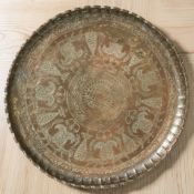 A large Indian engraved copper plated charger, diameter 64 cm.