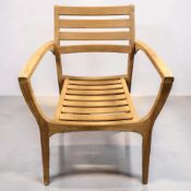 A teak garden armchair, width 60 cm.