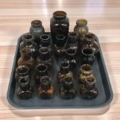 A collection of brown glass bovril bottles.