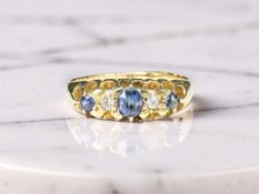 An 18ct gold diamond and synthetic sapphire five-stone ring,